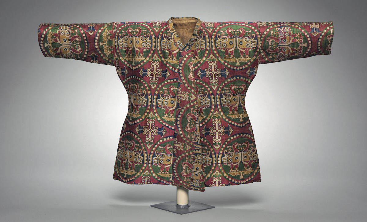 A Child’s silk coat. The two materials of the outer part and lining used in this child’s coat, which was found with a pair of trousers, reflect the exchange and blending of silk cultures along the Silk Road. Image credit: Cleveland Museum of Art 